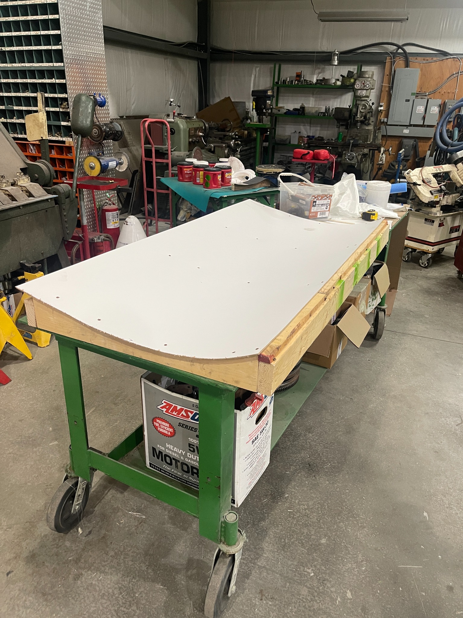 Full-size white tooling surface prepared on a workshop table