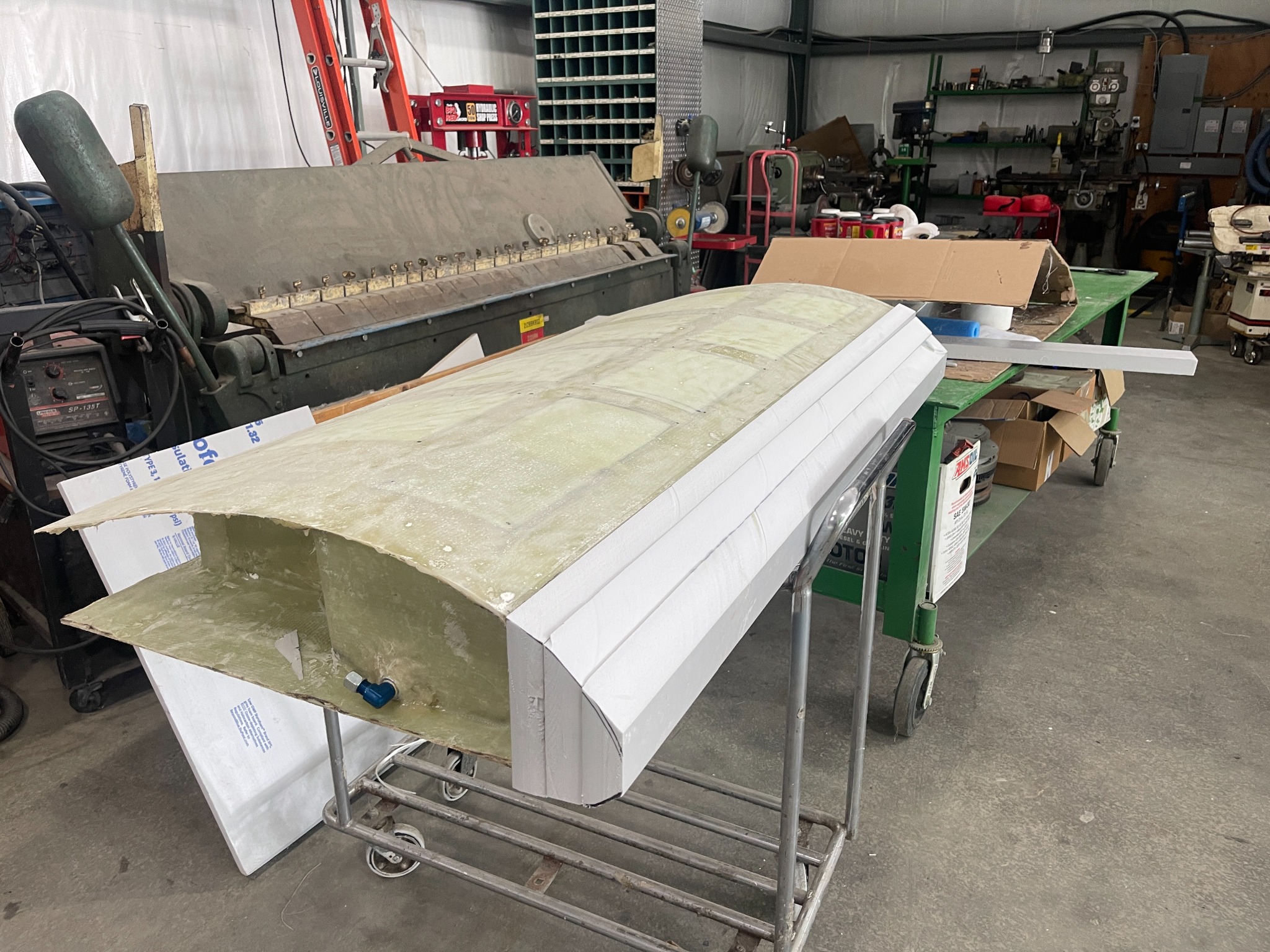 Curved composite tank shell and foam tooling during fabrication