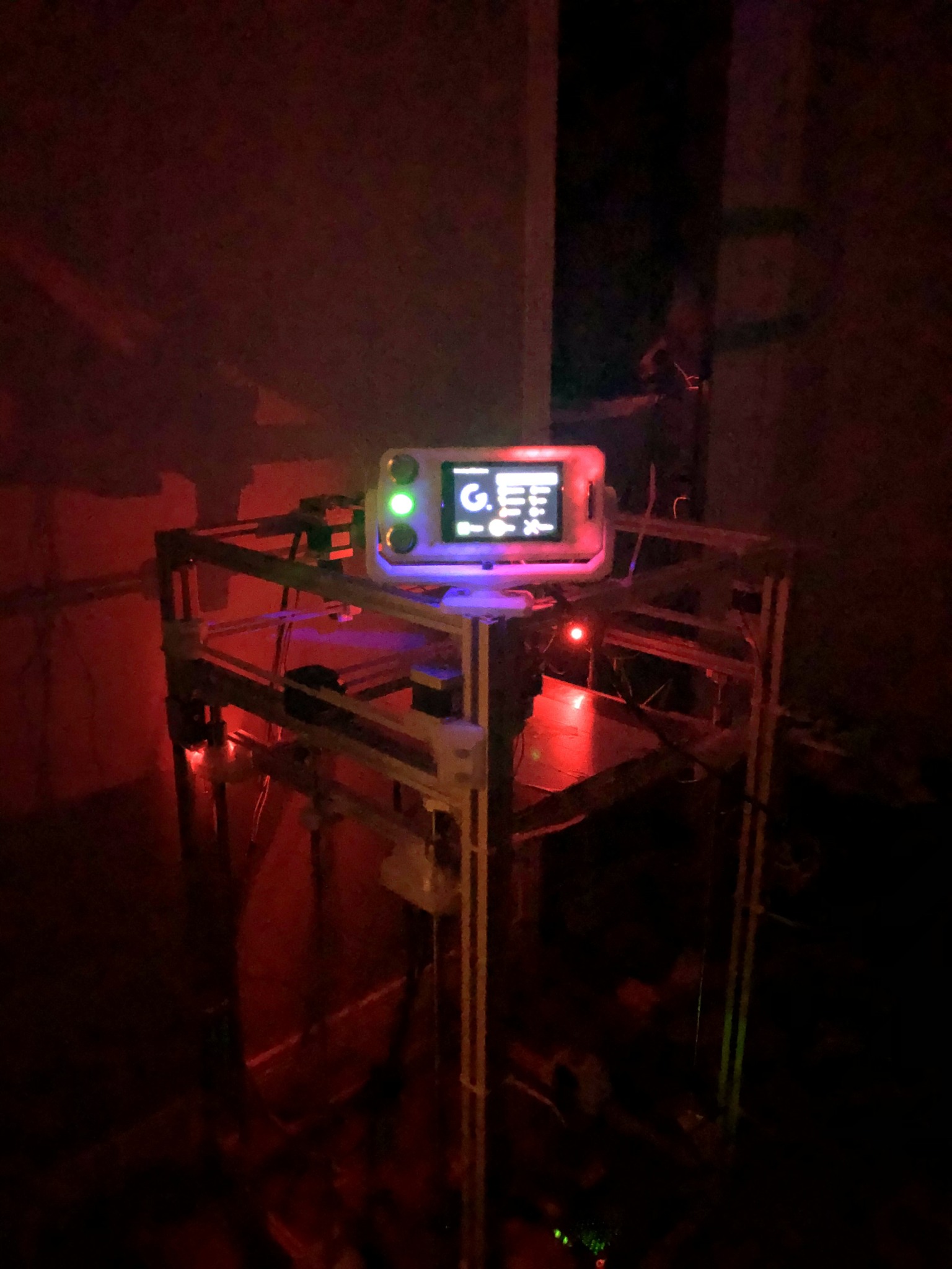 CoreXY printer operating at night with its control display illuminated