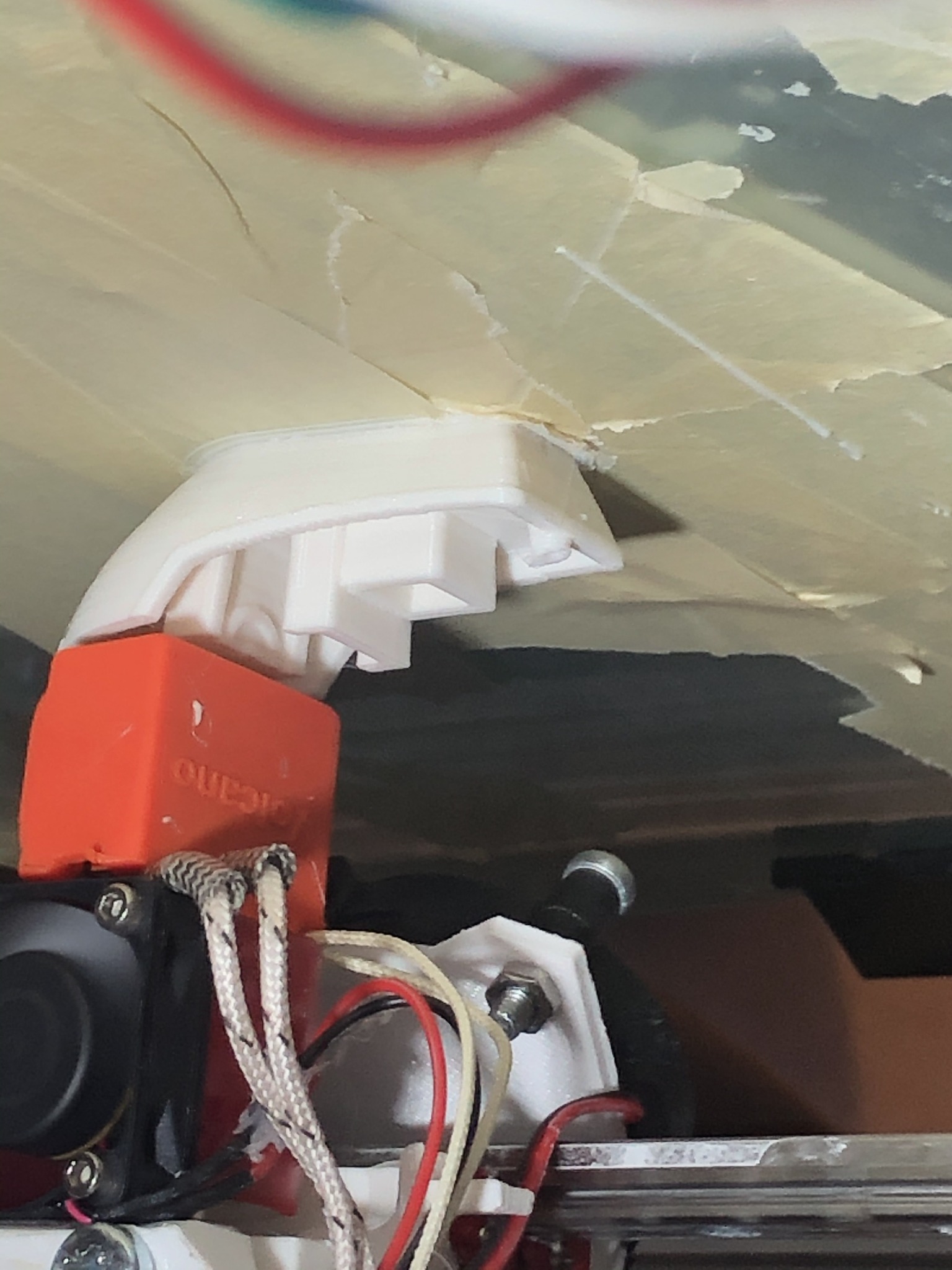 Close view of a damaged printed component near the print head