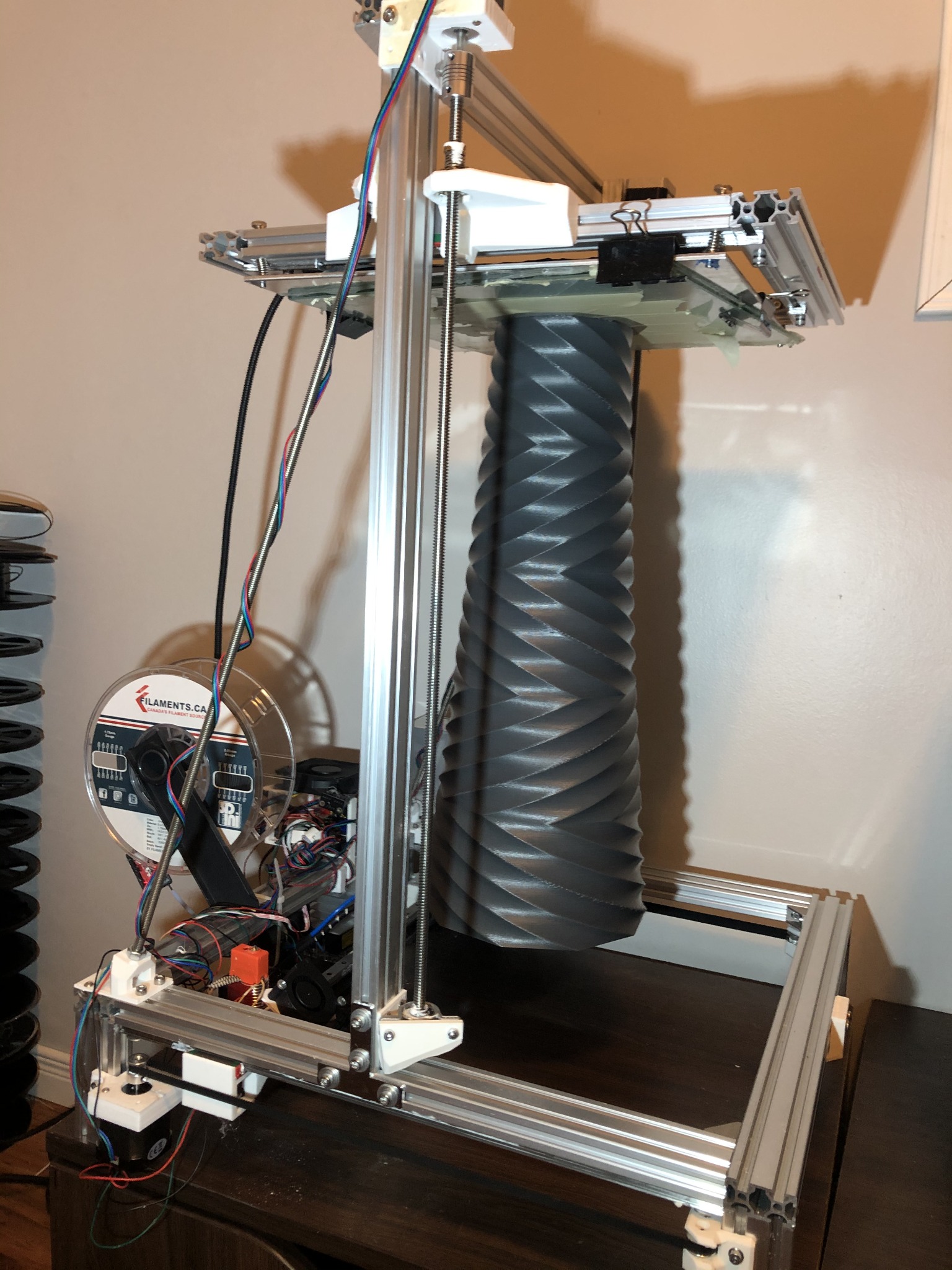 Custom CoreXY 3D printer producing a tall helical part