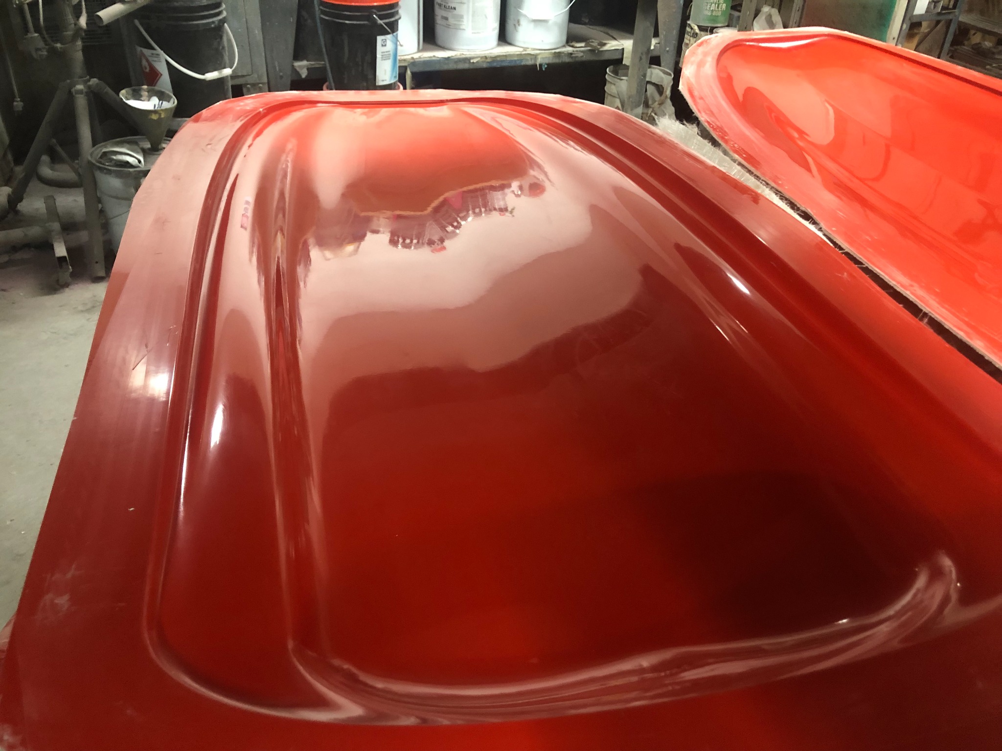 Red composite hydrofoil board shell after finishing