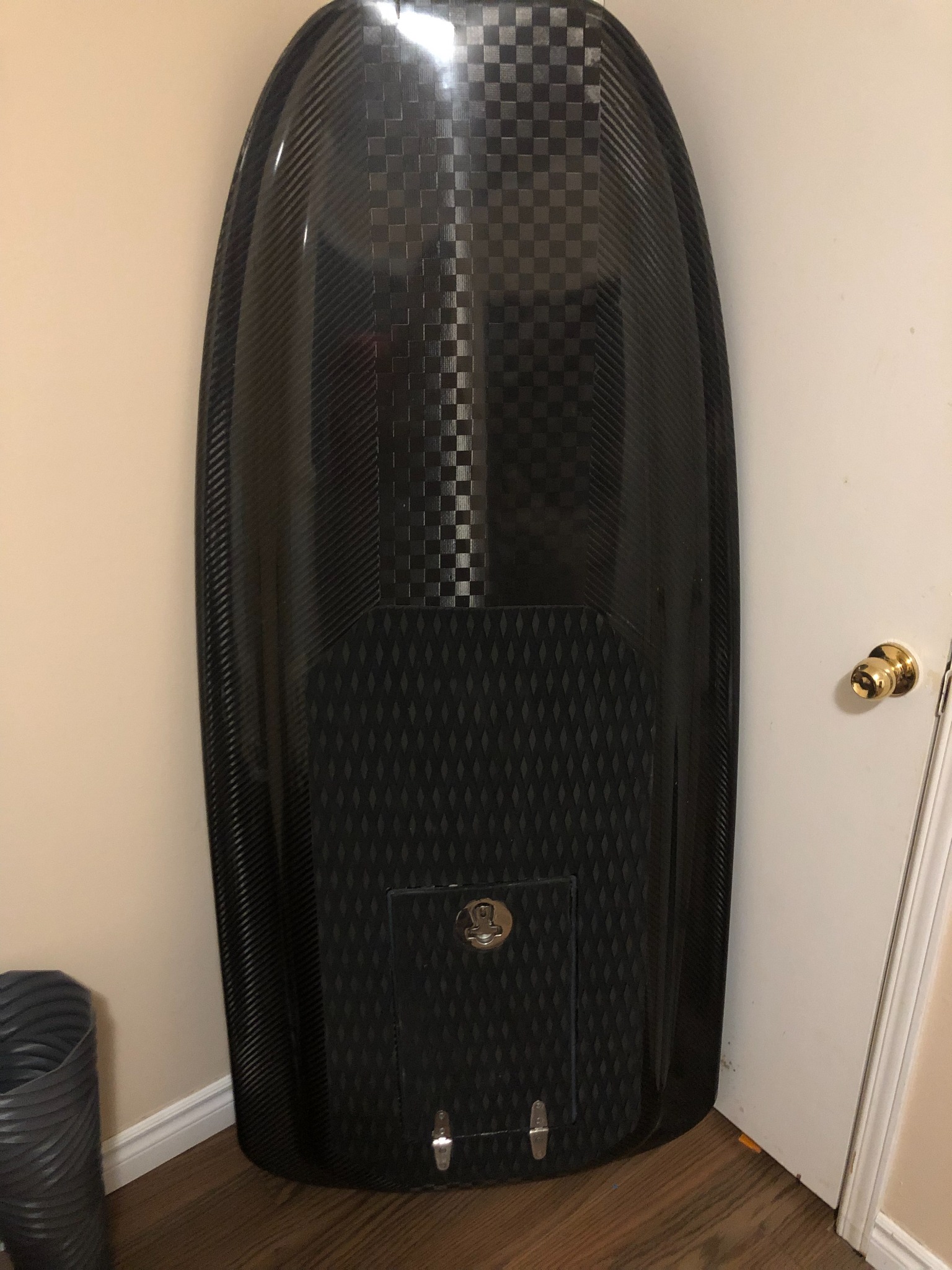 Finished carbon-fibre hydrofoil board stored upright