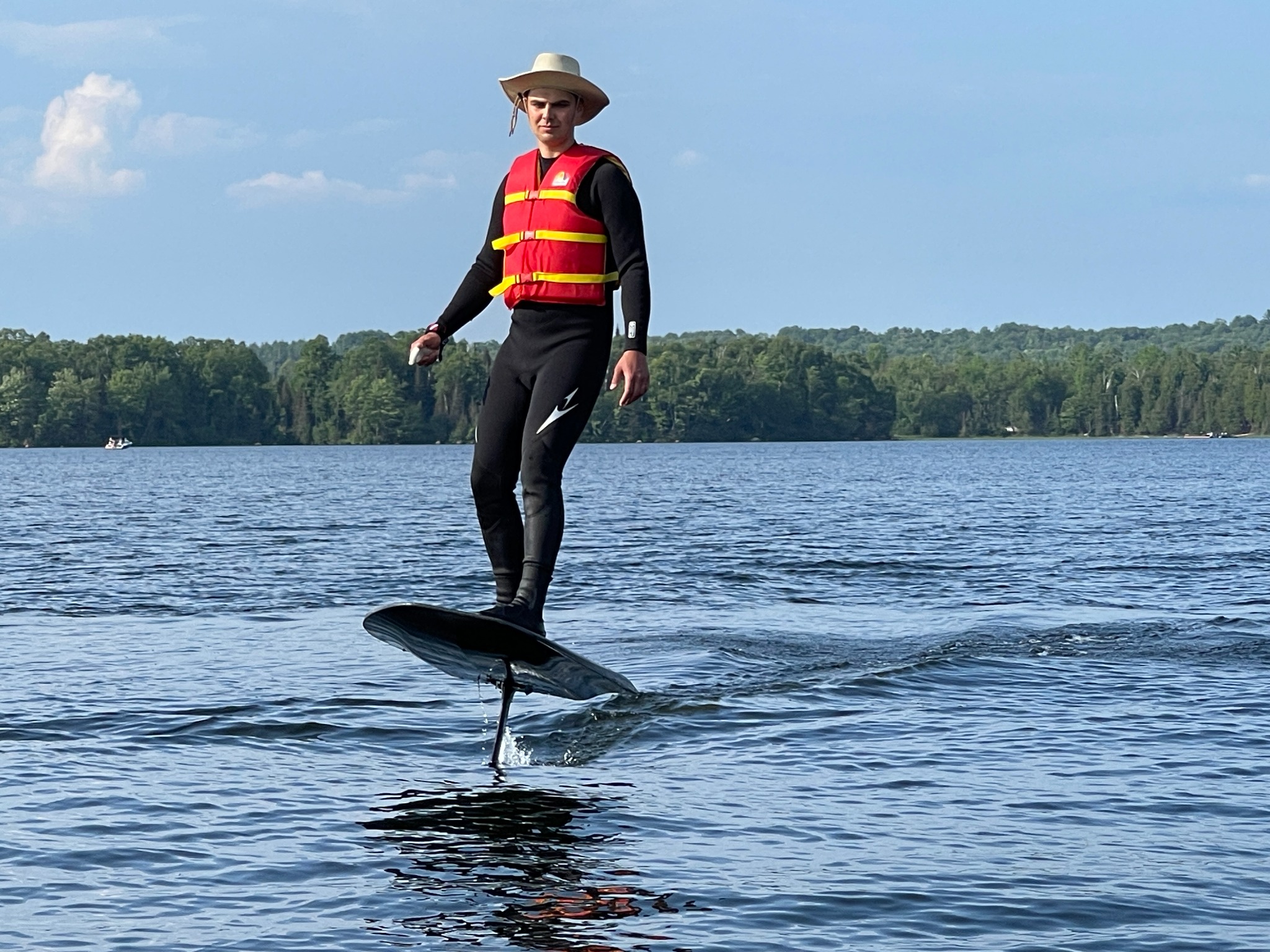 Andrii riding the electric hydrofoil board above the water