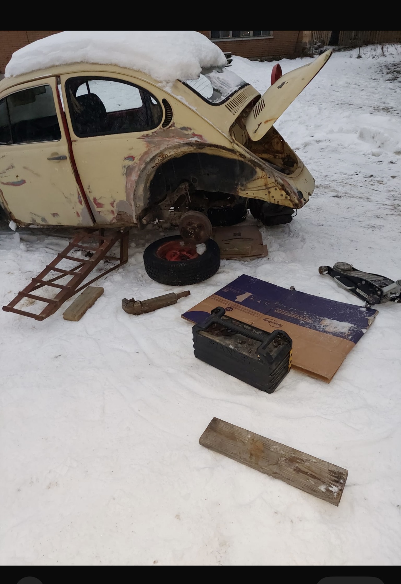 Volkswagen donor car being dismantled outdoors during winter