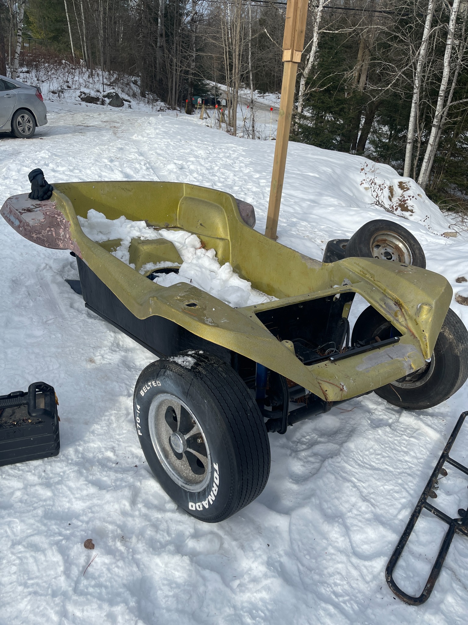 Stripped Manx dune buggy body and chassis during winter restoration work
