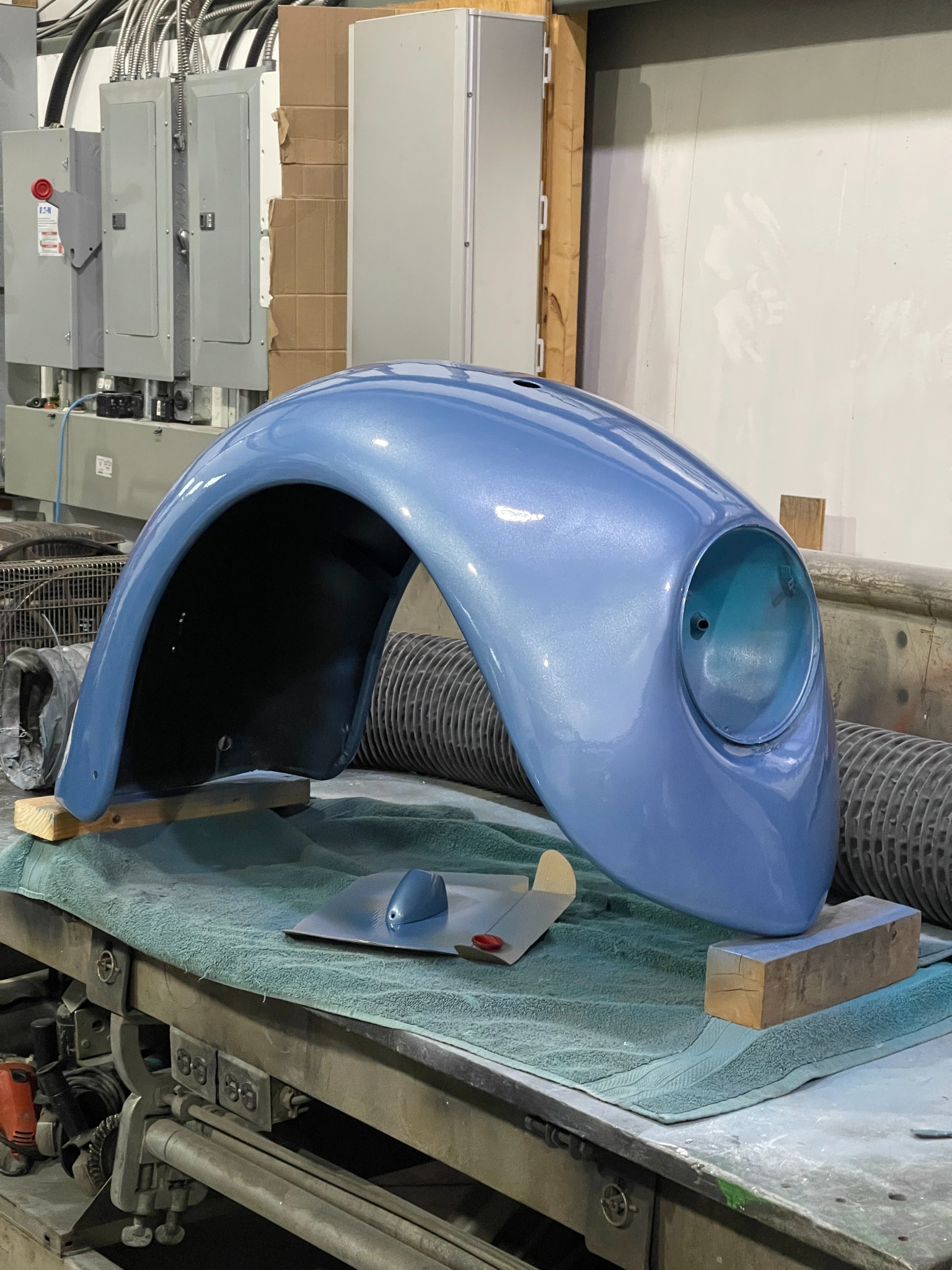 Mini bike body shell after receiving its blue finish