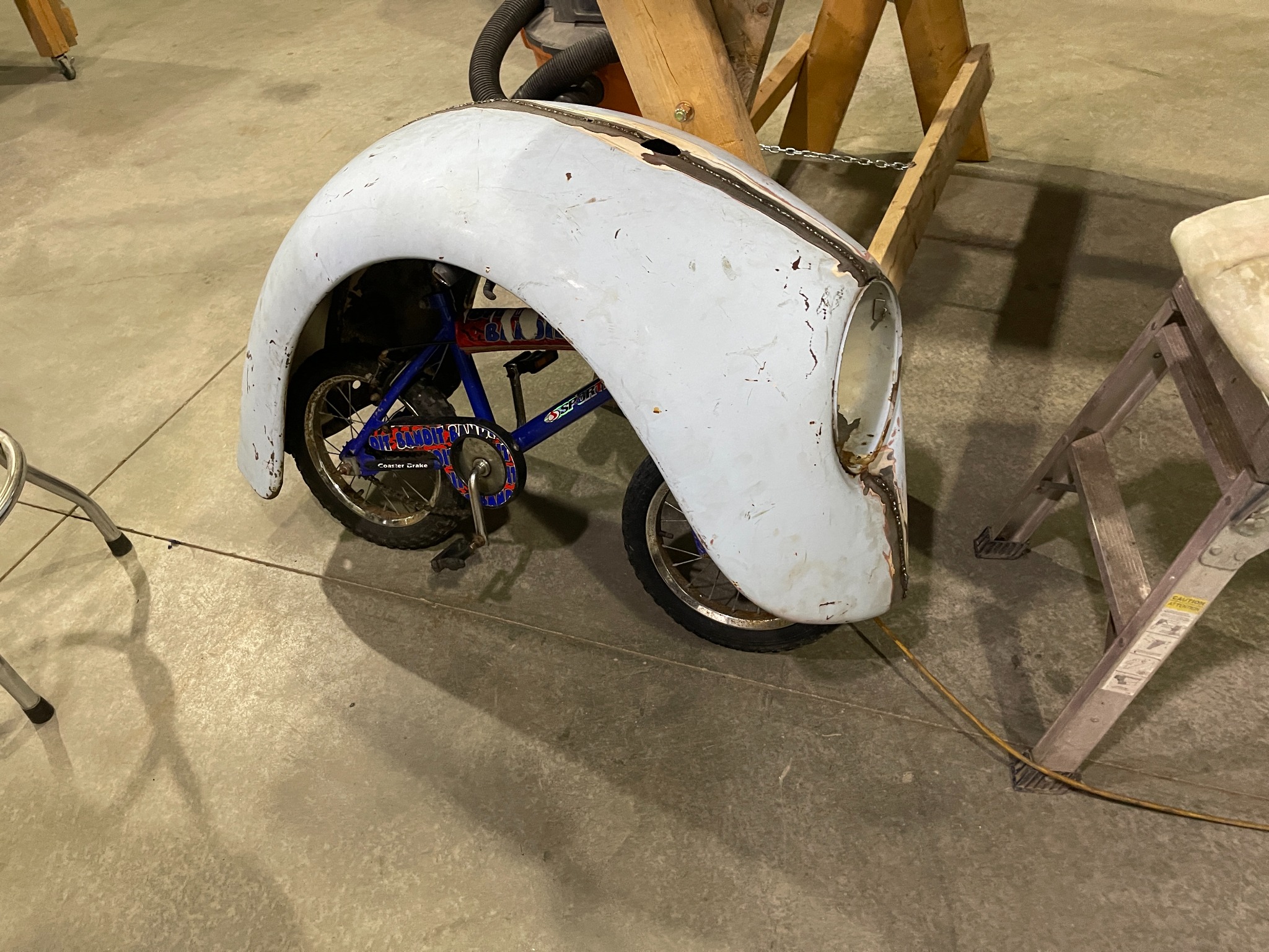 Mini bike wheel and electrical components installed beneath the body