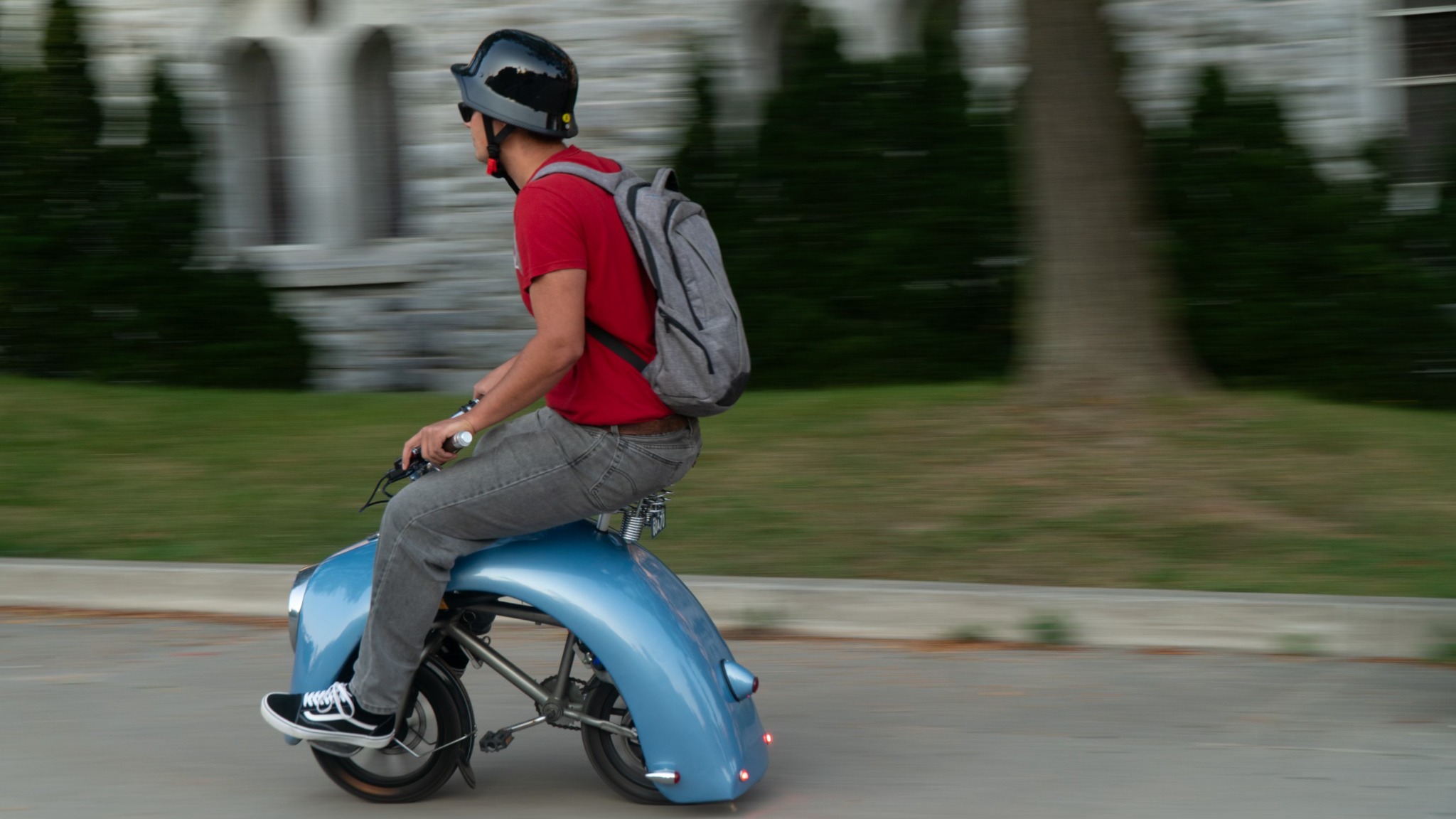 Side view of Andrii riding the completed electric mini bike