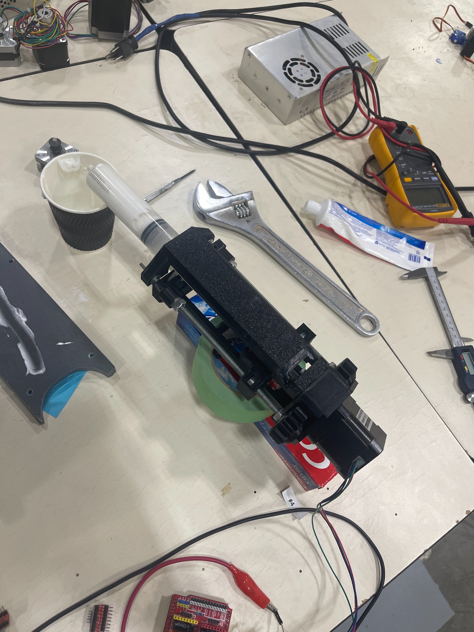 Paste extruder mechanism and syringe during testing