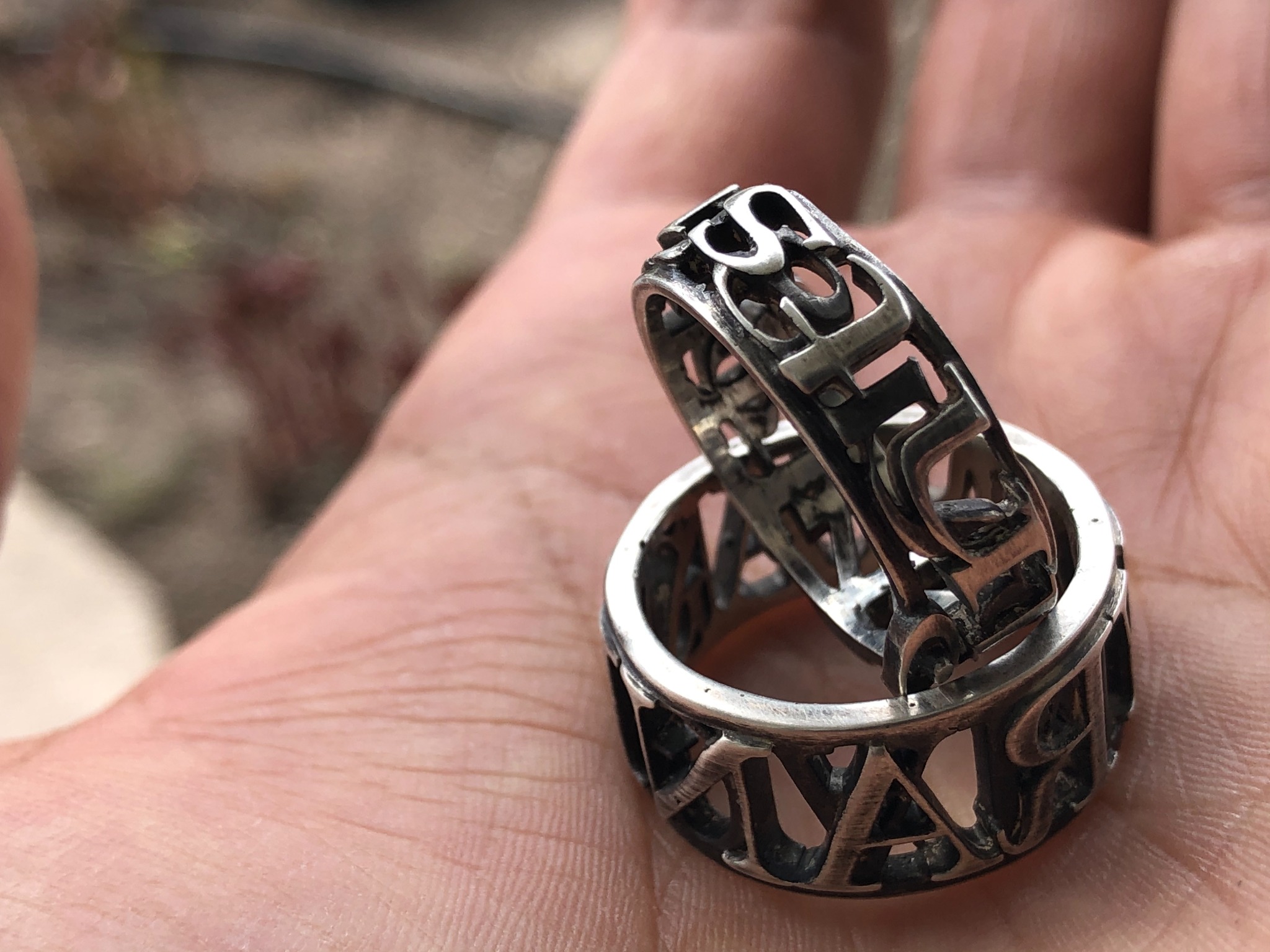Finished openwork metal rings held in a hand