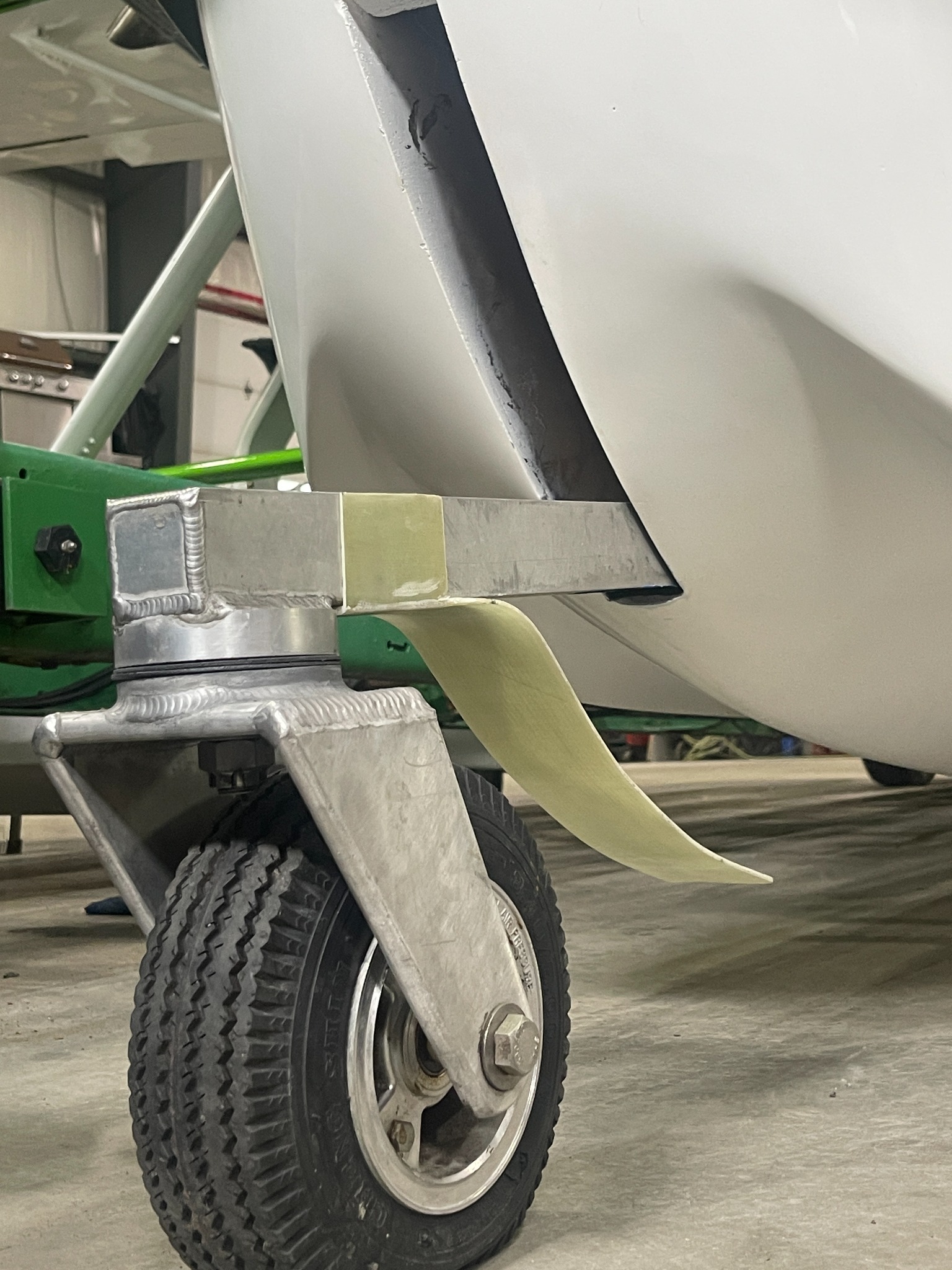 Finished composite front landing gear cover installed on an aircraft