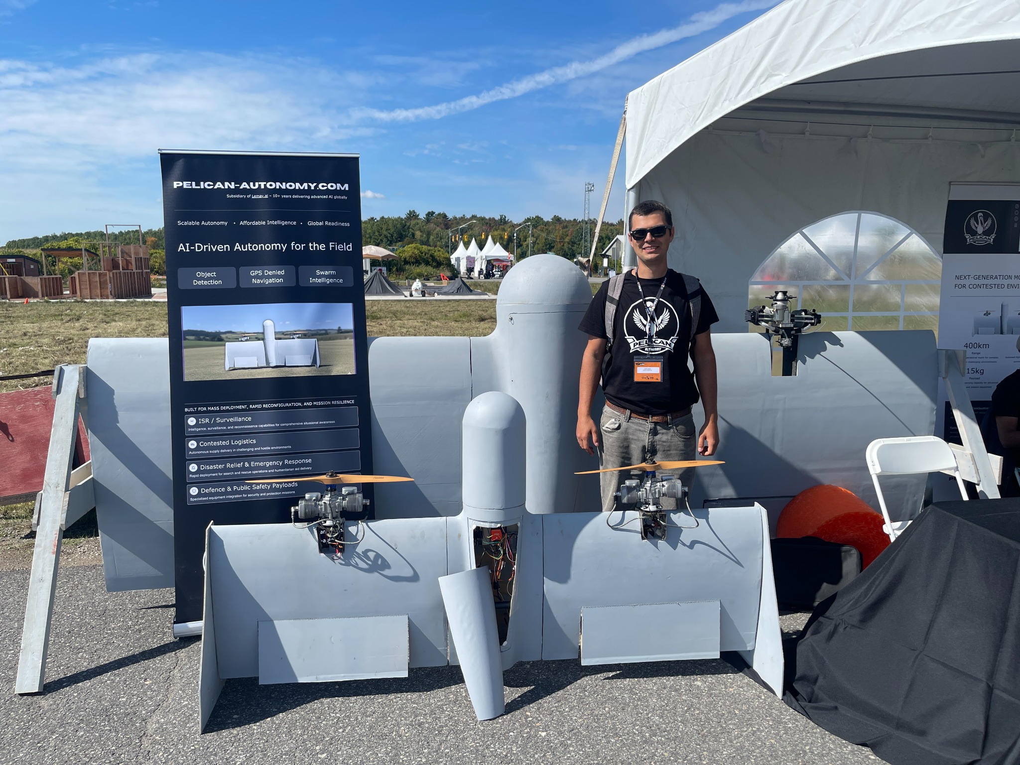 Andrii standing with the completed VTOL UAV at the Pelican Autonomy display