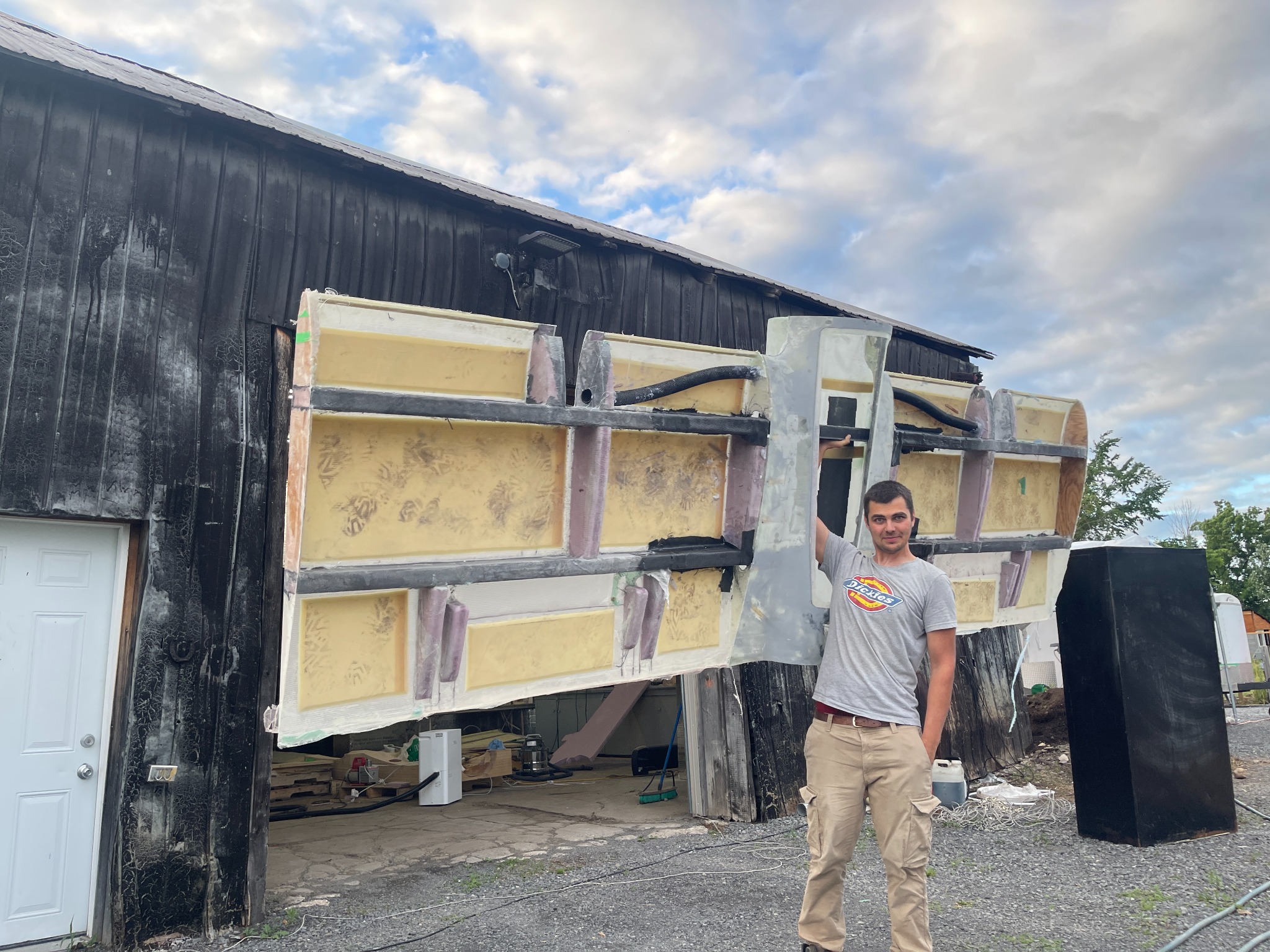 Andrii holding the full-scale VTOL UAV structure during fabrication