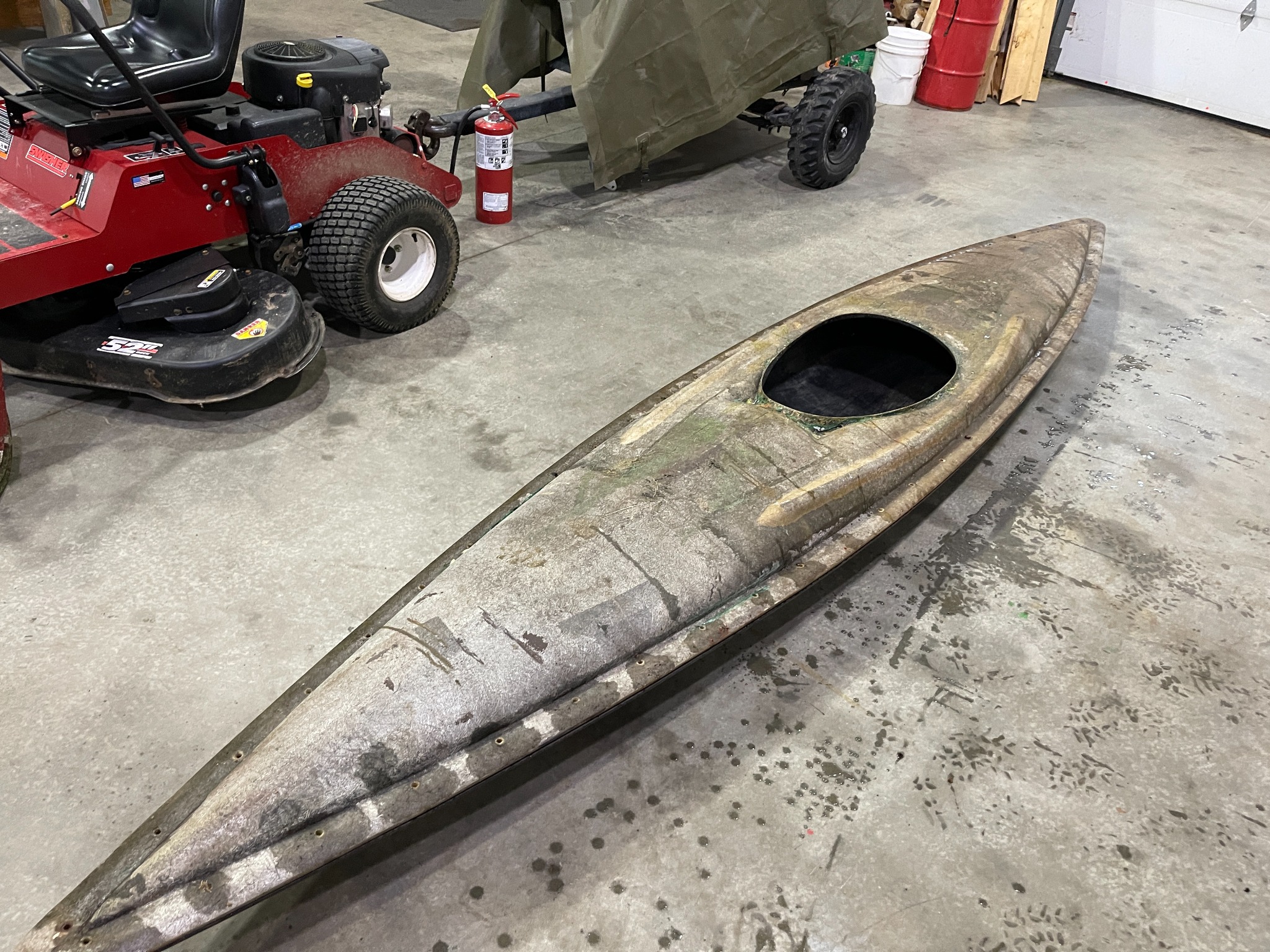 Unfinished fibreglass kayak shell in the workshop